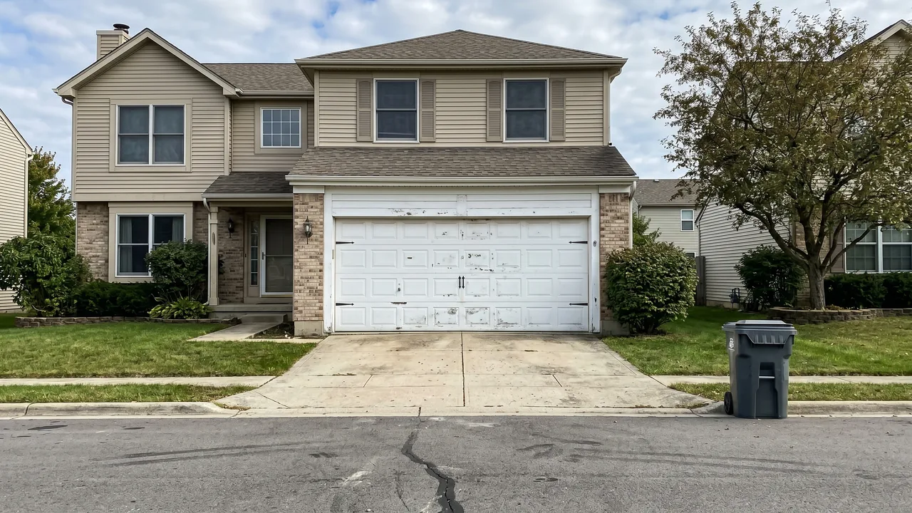 Before: a worn white short-panel garage door